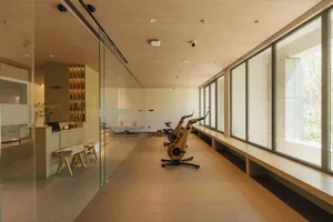 A modern interior fitness center with wooden flooring and equipment.