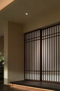 Contemporary design featuring wooden shoji screens and paper tapestry on a sliding door