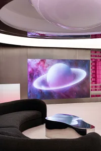A digital display showcasing a planet with Saturn-like rings in a futuristic setting.