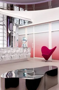 Modern minimalist lobby with metallic furniture and silver counter.
