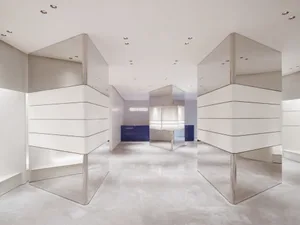 Modern minimalist retail space featuring glass paneling walls and floors