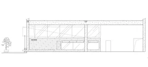 A modern building exterior with large glass panels and a steel frame.