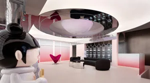 Modern hotel lobby featuring metallic mirrored ceiling and pink painted walls