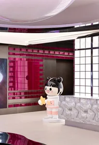 A modern interior design featuring a plastic character holding a star.