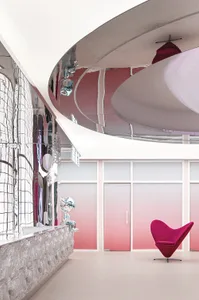 Modern interior design featuring glass, metal, fabric, and plastic materials in a lobby setting.