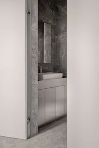 Minimalist bathroom with concrete tiles and a modern sink.