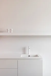 Modern minimalist bathroom with white fixtures and a sleek design.