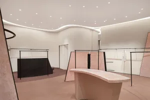 A minimalist retail store with white marble display areas, emphasizing modern and clean design.