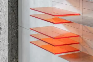 Modern floating glass shelves with red tint made of plexiglass