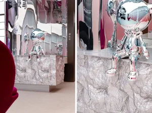 Modern museum installation featuring metallic sculptures and a table draped in aluminum foil.