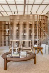 A modern, minimalist interior space featuring wooden architectural elements and furniture.