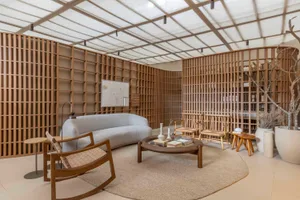 Modern living room featuring sleek, minimalist furniture and wooden paneled walls.