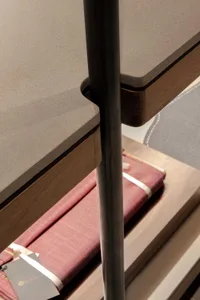 Modern metal and wood bookshelf display with books inside.