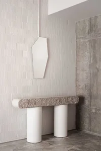 Modern minimalist console table with geometric shapes, featuring two cylindrical white bases topped with a textured gray terr