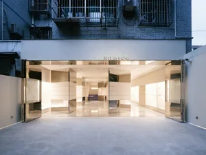 Modern retail storefront with large glass doors and windows.