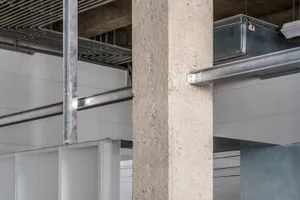 Concrete pillar and industrial-style ceiling in an indoor architectural setting