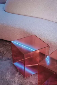 Modern acrylic coffee table with geometric design and LED lighting.