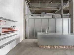 A sleek, minimalist interior design featuring metallic finishes and a modern aesthetic.