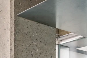 Modern interior design featuring metal walls and concrete floor.