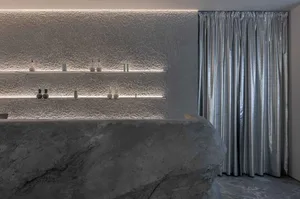 Modern spa room featuring natural stone and concrete textures.