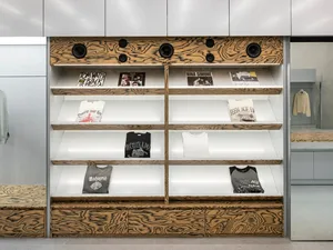 A retail display with wooden panels featuring records and t-shirts.
