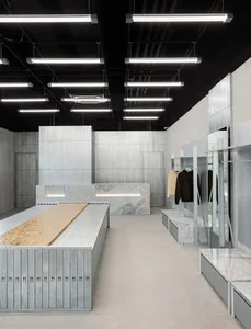A minimalist retail store featuring a concrete and marble interior.