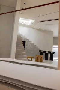 A minimalist modern interior design featuring a concrete staircase