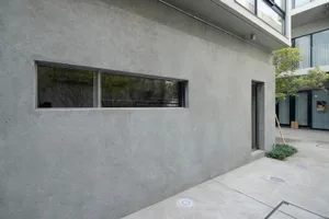 Modern building exterior with concrete walls and minimalist design.