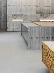 A modern interior storefront featuring concrete and marble materials.