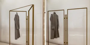 Modern interior design featuring a metal-framed clothing display