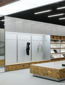 A modern retail space featuring a minimalist, industrial design with metal structures and large display shelves.