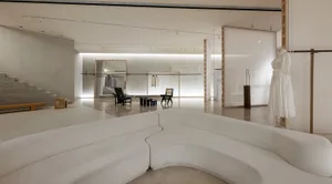 A modern retail store with a minimalist white space design, featuring a clean and uncluttered environment.