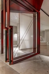 A modern storefront with glass walls and a steel frame.