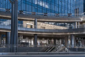 A modern shopping center interior with glass and metal walls.