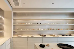 Shelves displaying ceramic tea cups and teapots.