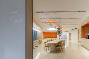Minimalist coffee shop interior with wood finishes and open seating.