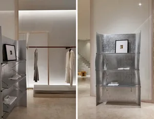 Modern minimalist clothing retail space with metal shelving.