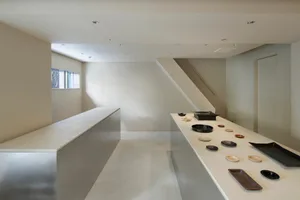 A minimalist interior space with concrete walls and floors.