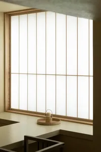 A minimalist interior with white paper shoji screens and soft lighting.