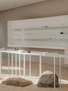 A minimalist commercial design showcasing sleek white surfaces and a combination of materials.