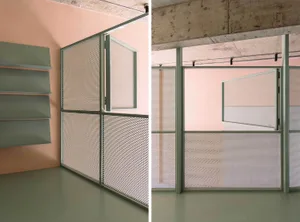 A minimalist interior design featuring modern concrete walls and a perforated metal screen.