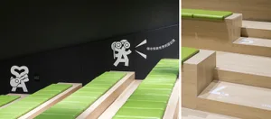 Modern interior design featuring green padded seating arrangements.
