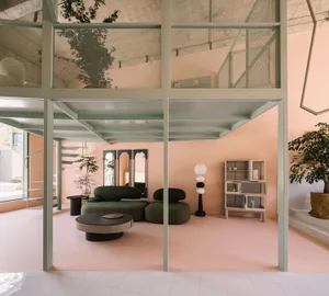 A modern living room with concrete elements and mint green accents.