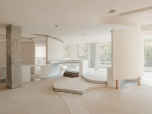 A modern office space featuring concrete flooring and walls