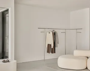 Minimalist clothing showroom with neutral tones and modern design.