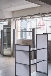 Industrial-style interior with metal shelving system and minimalist design elements.