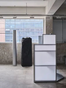 Modern minimalist art installations featuring concrete and metal elements