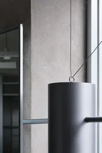 A modern office space featuring grey concrete columns and metal elements.