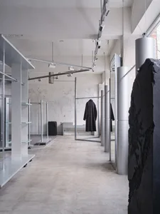 Modern shopping center interior with concrete flooring and minimalist design.