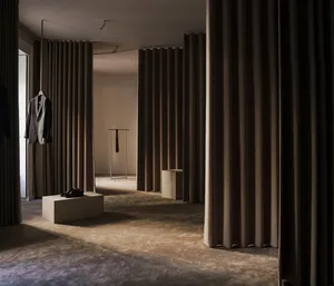 Clothing retail space featuring fabric curtains and shelving